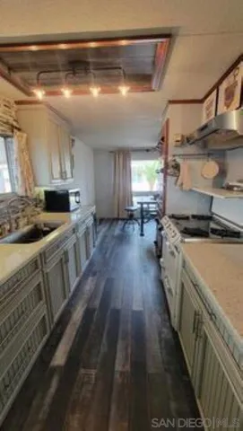 a kitchen with stove and cabinets
