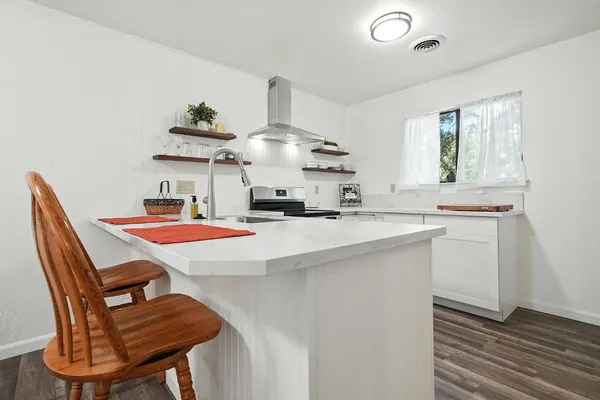 a room with a table chairs and a refrigerator