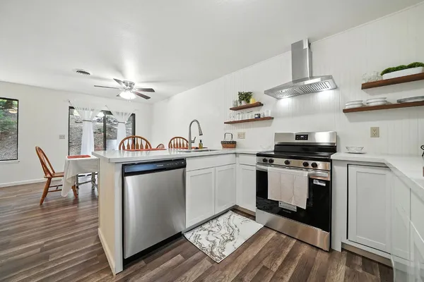 a kitchen with a sink cabinets and stainless steel appliances
