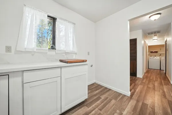 a hallway with a sink and a window
