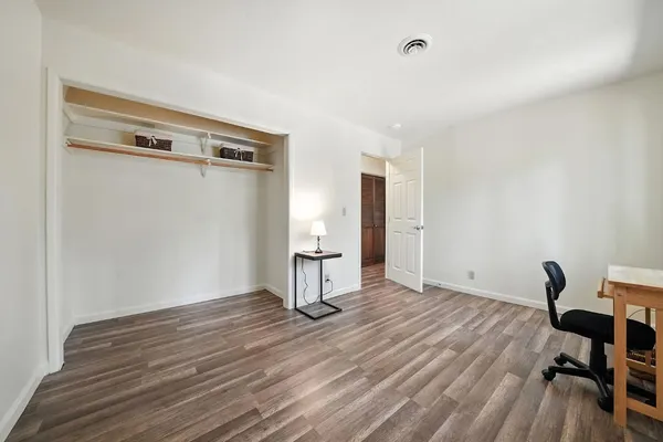 a view of a room with wooden floor and a sink