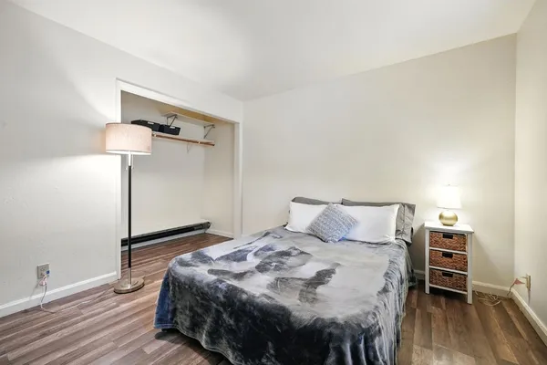 a bedroom with a bed and dresser