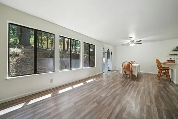 a living room with furniture and wooden floor