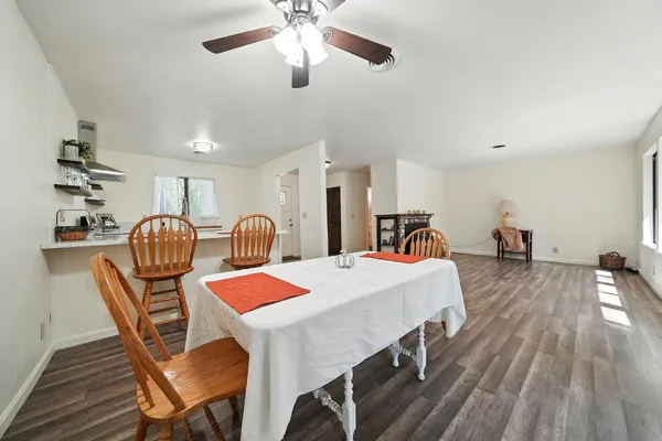 a dining room with furniture and wooden floor