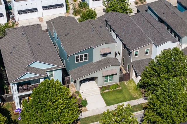 an aerial view of multiple houses with yard