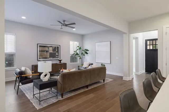 a living room with furniture potted plant and a window