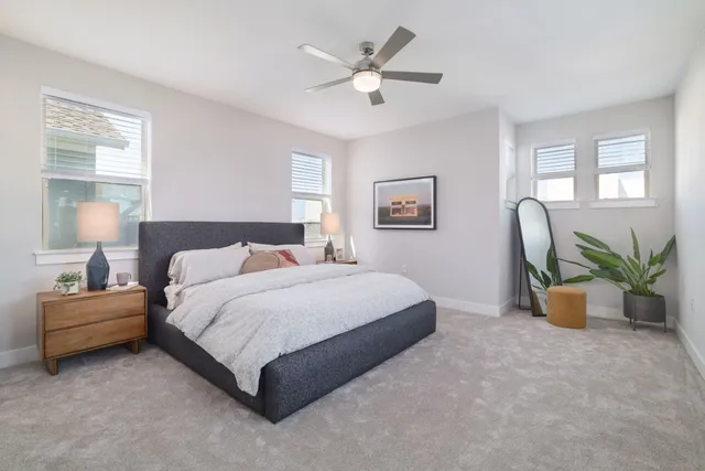 a spacious bedroom that has a bed and a window