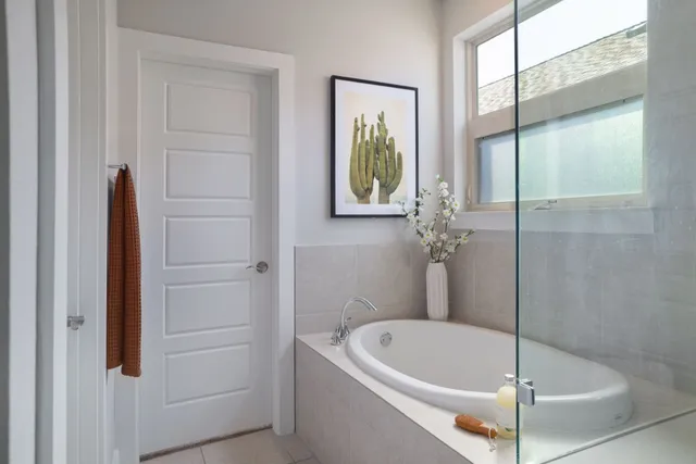 a bathroom with a bathtub and shower