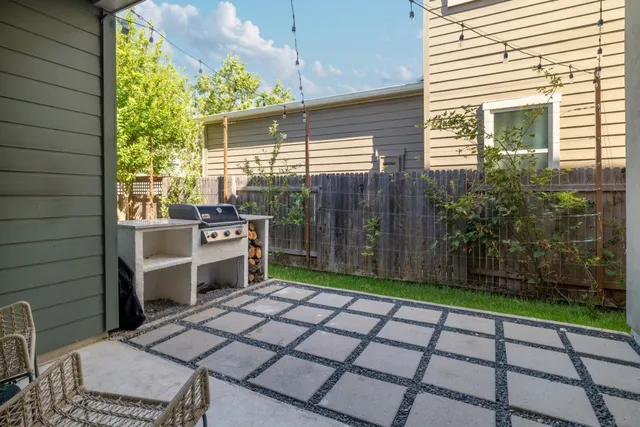 a backyard of a house with barbeque oven