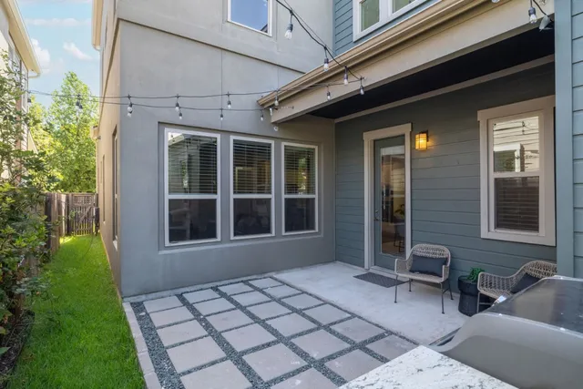 a view of house with backyard outdoor seating and plants