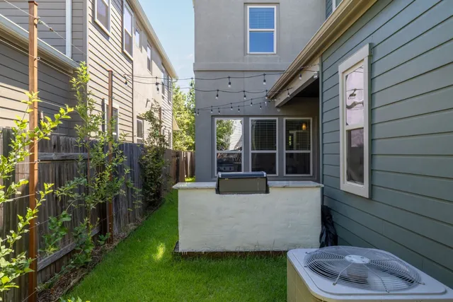 a view of an house with backyard and sitting area