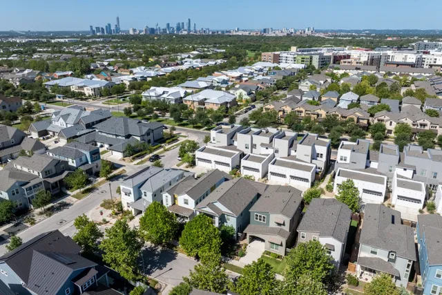 an aerial view of residential houses with outdoor space