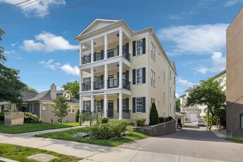 a bathroom with a granite countertop sink a toilet and a mirror