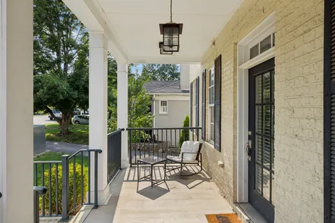 a spacious bedroom with a bed couch and window