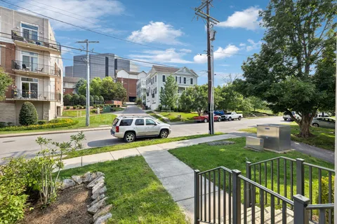 a living room with furniture and floor to ceiling windows