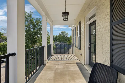 a kitchen with white cabinets and refrigerator