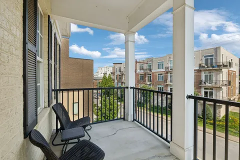 a kitchen that has a lot of cabinets a sink and wooden floor
