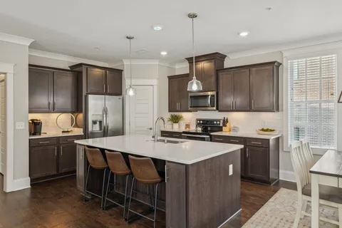a bathroom with a granite countertop sink a toilet and a mirror
