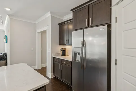 a bathroom with a granite countertop sink a toilet a mirror and shower