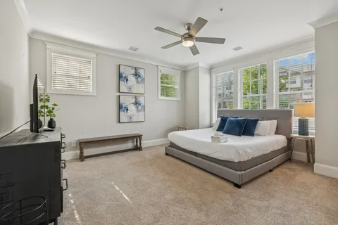 a living room with furniture and a flat screen tv with wooden floor