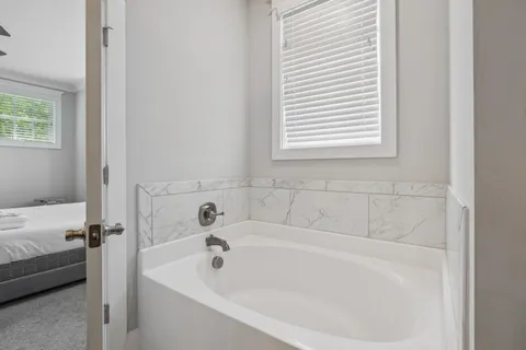 a kitchen with stainless steel appliances granite countertop a sink a stove a refrigerator a center island and cabinets