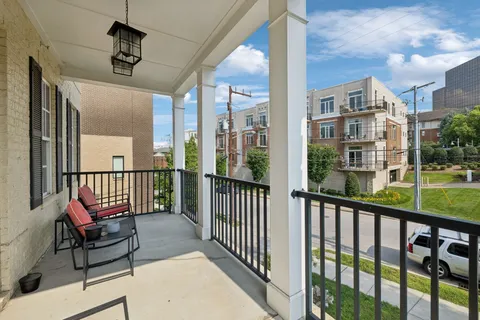 a kitchen with granite countertop a table chairs stainless steel appliances and cabinets