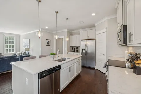 an aerial view of a house with large swimming pool