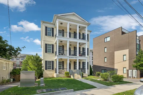 a view of a dining room with furniture wooden floor and chandelier