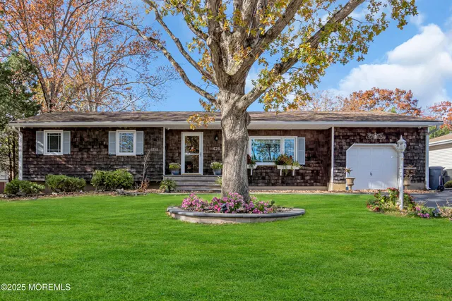 a front view of a house with garden and porch