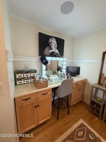 a kitchen with a sink cabinets and wooden floor