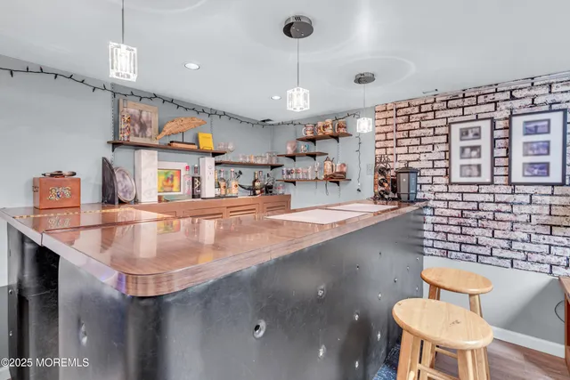 a kitchen with a table chairs stove and living room view