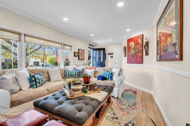 a living room with furniture and large window with outer view