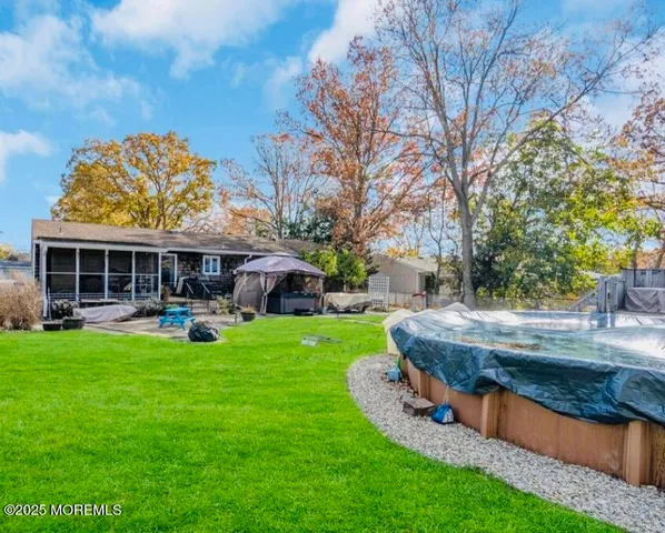 a view of a house with backyard sitting area and garden
