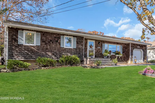 a front view of house with yard and outdoor seating