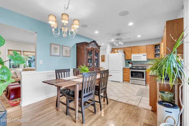 a view of a dining room with furniture a chandelier and wooden floor