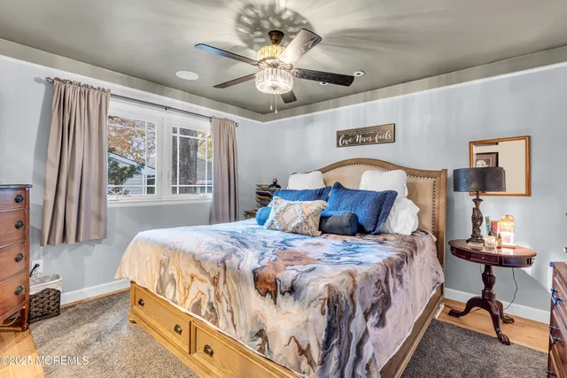 a bedroom with a large bed and a chandelier