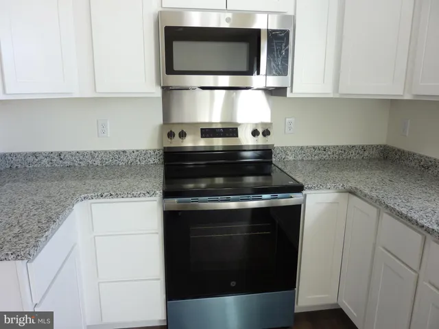 a view white cabinets and sink