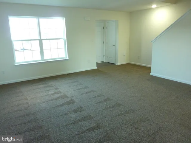 an empty room with a empty space and window