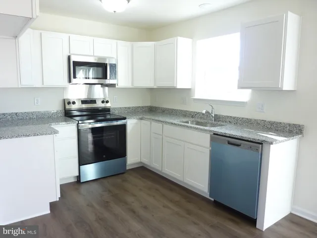 a kitchen with a stove and a microwave