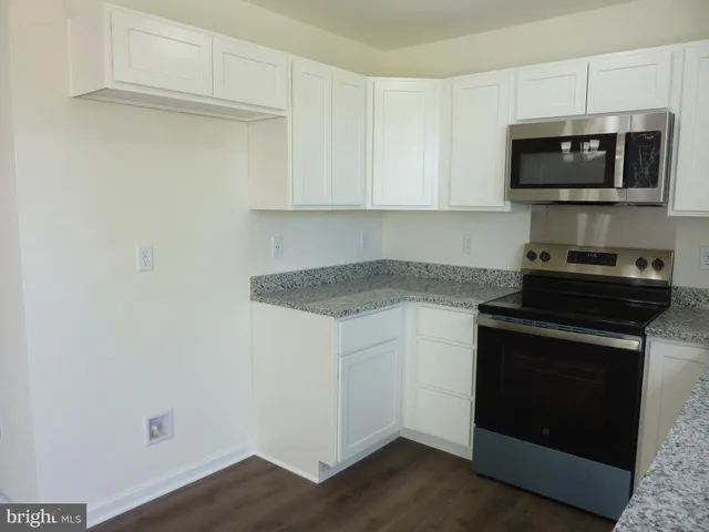 a kitchen with a stove and a microwave