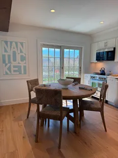 a view of an empty room with wooden floor and cabinet