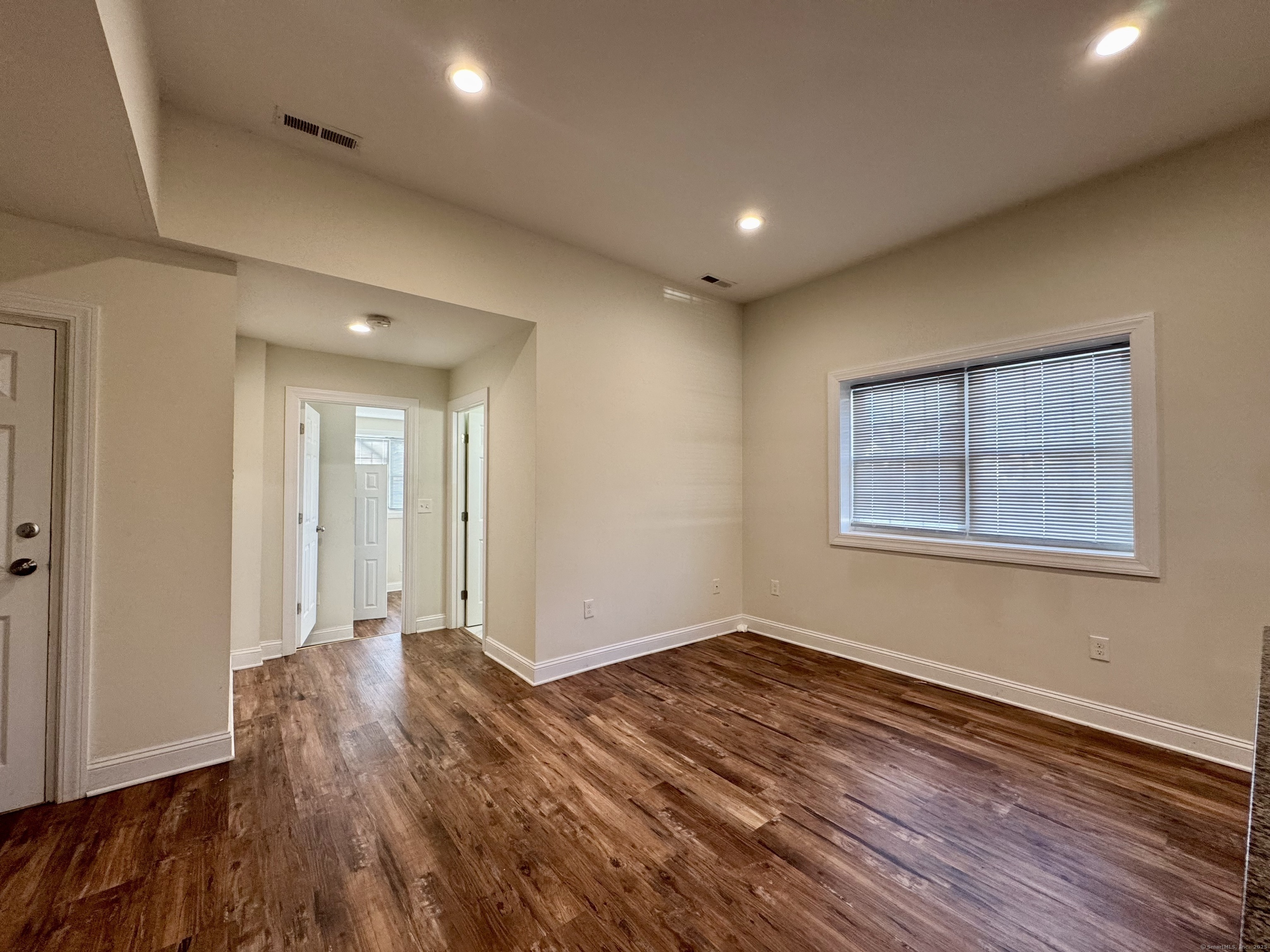 950 Lindley Street Bridgeport, CT 06606 - Photo 13 of 14 a view of an empty room with wooden floor and a window