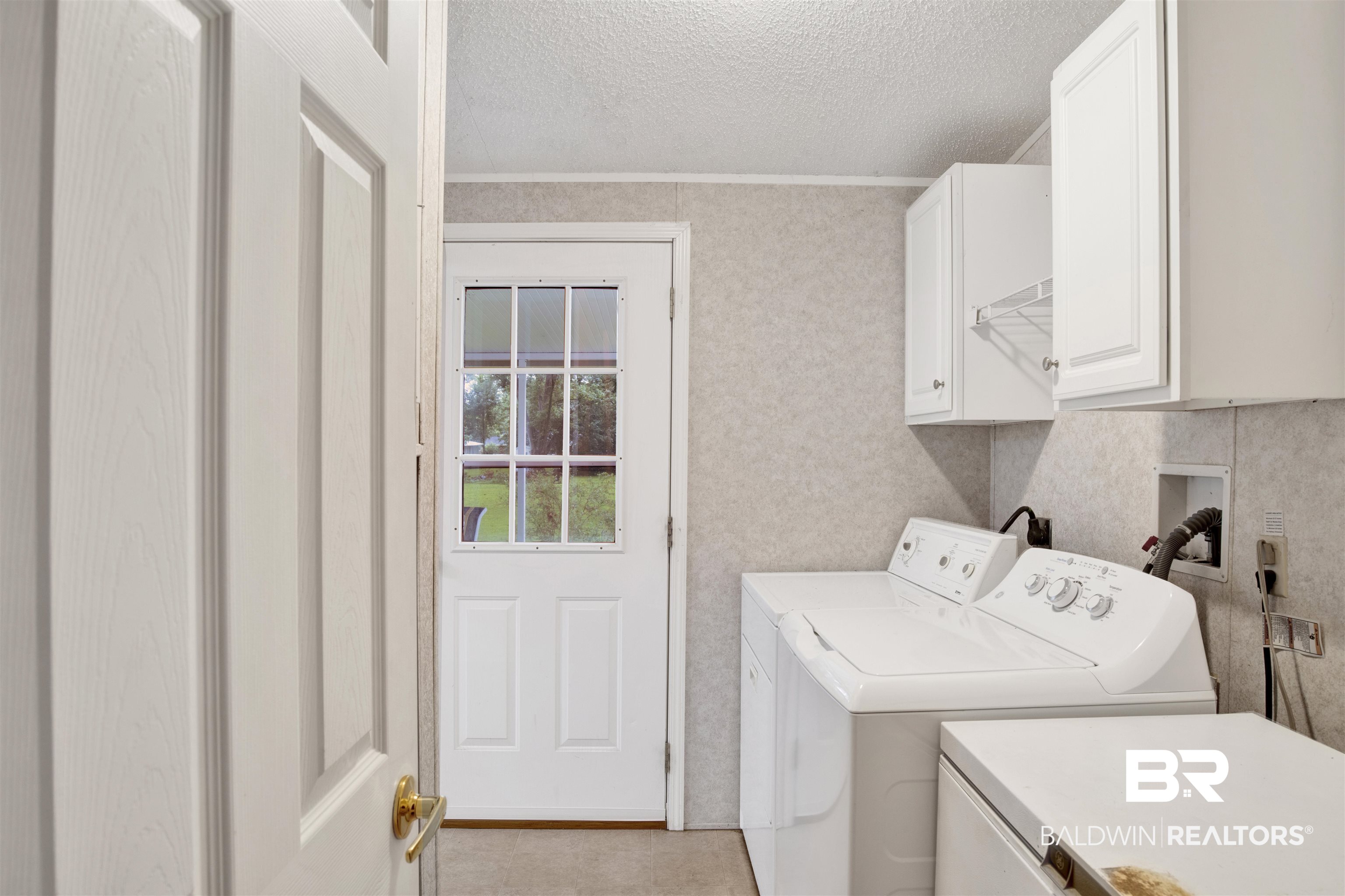 25700 County Road 71 Robertsdale, AL 36567 - Photo 11 of 40 Laundry room with cabinet space, independent washer and dryer, a textured ceiling, and ornamental molding