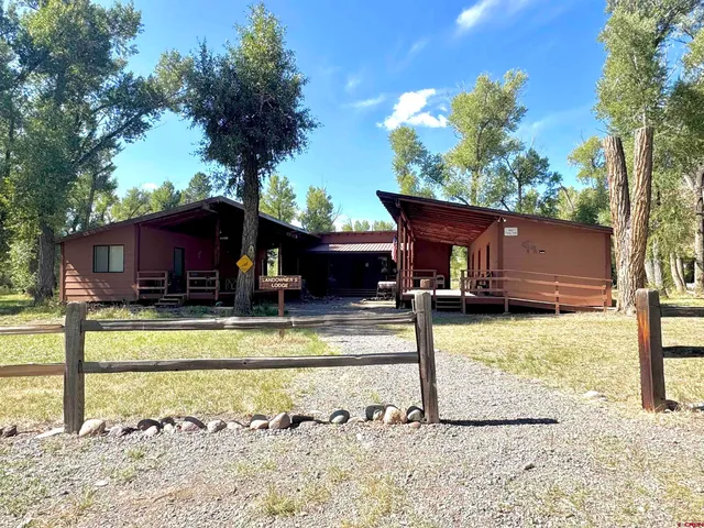 a view of a house with backyard swimming pool and sitting area