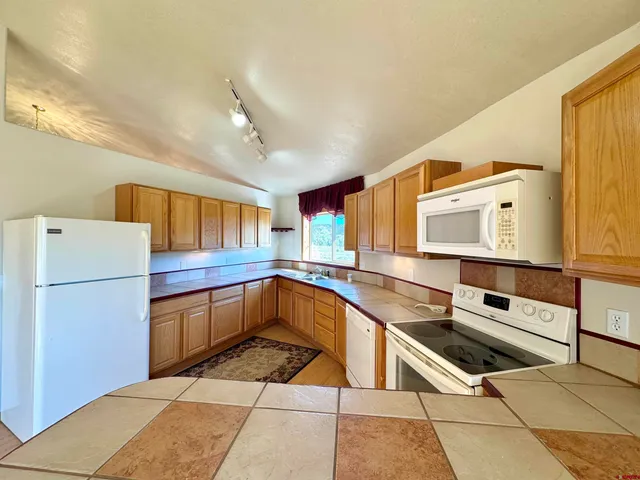 a kitchen with a sink a stove and a refrigerator