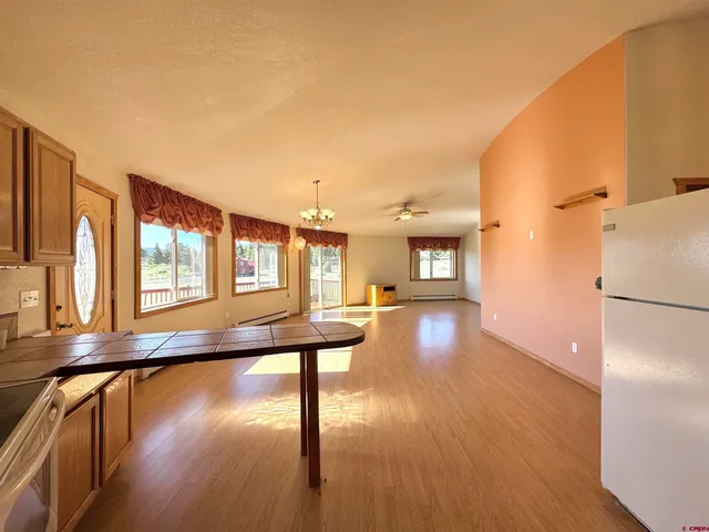 a view of a living room hardwood and a kitchen
