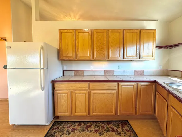 a kitchen with a refrigerator and window
