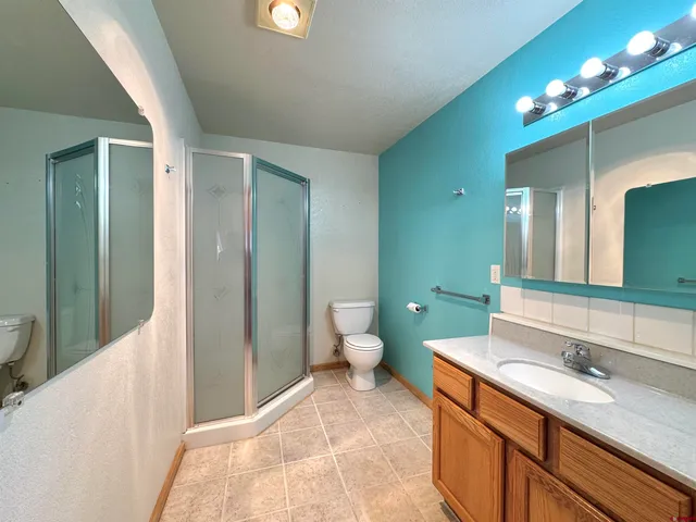 a spacious bathroom with a toilet sink and mirror