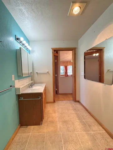 a view of a kitchen with a sink and mirror