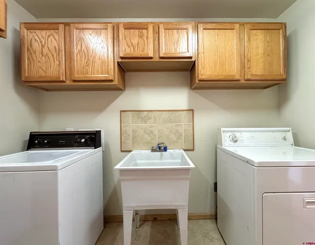 a kitchen with a sink cabinets and appliances